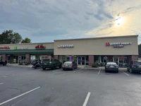 a parking lot with cars parked in front of a store